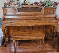 Front view of Baldwin upright piano with matching bench