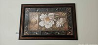 full view of framed floral print on wall
