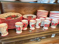 Overall view of stacked plates, bowls and row of mugs
