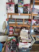 Shelf with wrapping paper rolls, gift bags, bins of bows and loose décor