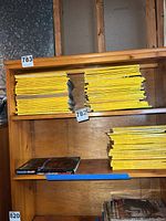 Three shelf stacks of yellow-spined National Geographic magazines
