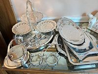 Full lot showing tiered server, stack of trays, round tray, gravy boat and warmer stand