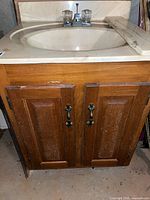 Front view of vanity showing countertop, sink, faucet, cabinet doors