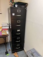 Full view of black 5-drawer Steelcase vertical file cabinet in room