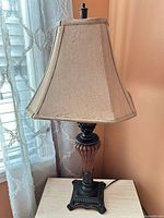 Full view of lamp showing base, body and shade