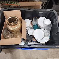 Overview of tote with dinnerware, glassware and decor