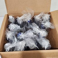 Open carton showing numerous sealed sleeves of clear plastic cups