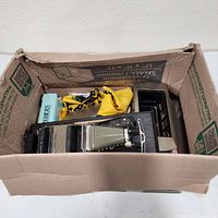 Box overview showing die-cast cars, cable car model, book and cloth