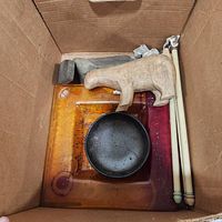 Box with glass ashtray, ceramic bowl, wood bear, stone base, candles