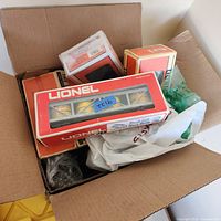 Open carton showing several Lionel window boxes and loose items
