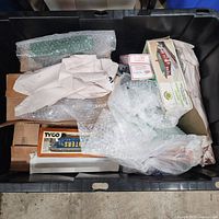 Overall view of storage tote with boxed and wrapped train items
