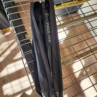 Tripod folded inside black zippered carry case