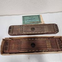 Two Ukelins with booklet on table