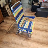 Side view illustrating low-seat profile, folding frame and fabric pattern