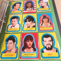 Nine Topps Superman sticker cards in binder page