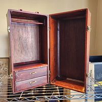 Cabinet open showing interior layout with hanging rod and drawers