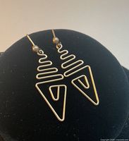 front view of both earrings on display stand