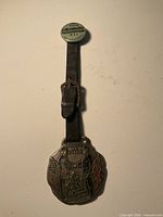 Full view of leather-strap fob with attached pin