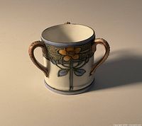 Front view showing floral design and two handles