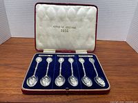 Open case showing all six sterling spoons and interior printing