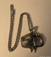 Pendant and full chain laid flat showing design and clasp
