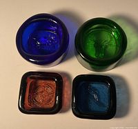 Top view of all four coloured pressed glass dishes