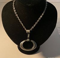 Full view of necklace on display bust showing oval pewter pendant and chain