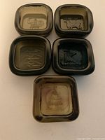 Five square glass dishes showing all motifs