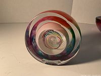 Front view showing multicolour spiral design inside clear glass