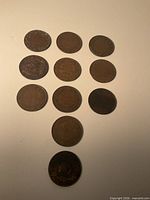 11 assorted Canadian one-cent coins laid out for overall view