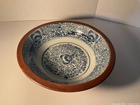 Top view showing complete interior blue floral pattern and brown rim