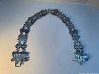 Full length view of sterling silver Chinese character and coin belt laid flat