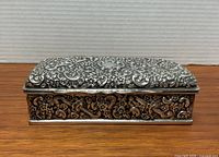 Top view showing full repousse design and central blank cartouche