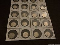 Array of silver Canadian quarters in 2x2 flips labelled 1964-1968