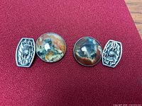 Front view showing agate cabochons and thistle terminals