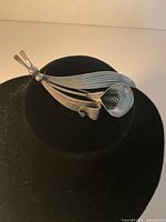 Front view of sterling floral brooch on display