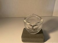 Overall view of clear ribbed glass bowl on foam block