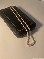Full length view of knotted pearl necklace