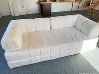 front view of off-white three-seater sofa bed