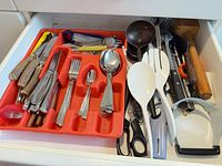 Drawer overview showing flatware tray and assorted utensils