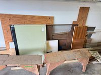 overview of wood offcuts, glass panes, screen and two sawhorses
