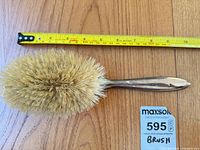 Full brush alongside tape measure showing length