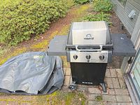 Full view of grill with cover beside it on patio