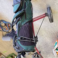 Golf bag strapped to red Sun Mountain Speed Cart