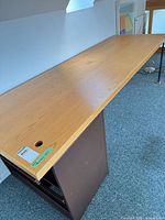 Full view of desk top on cabinet and leg