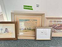 All four framed prints leaning against wall to show variety and scale