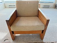 Front view of armchair showing wood frame, cushions, upholstery