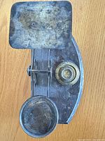 Overhead view of metal balance scale with two platforms and attached brass weight set