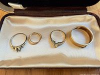 Four rings in jewelry box