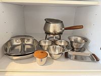 Group view of all stainless steel pieces on shelf